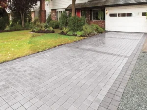 Gray paved driveway with landscaping